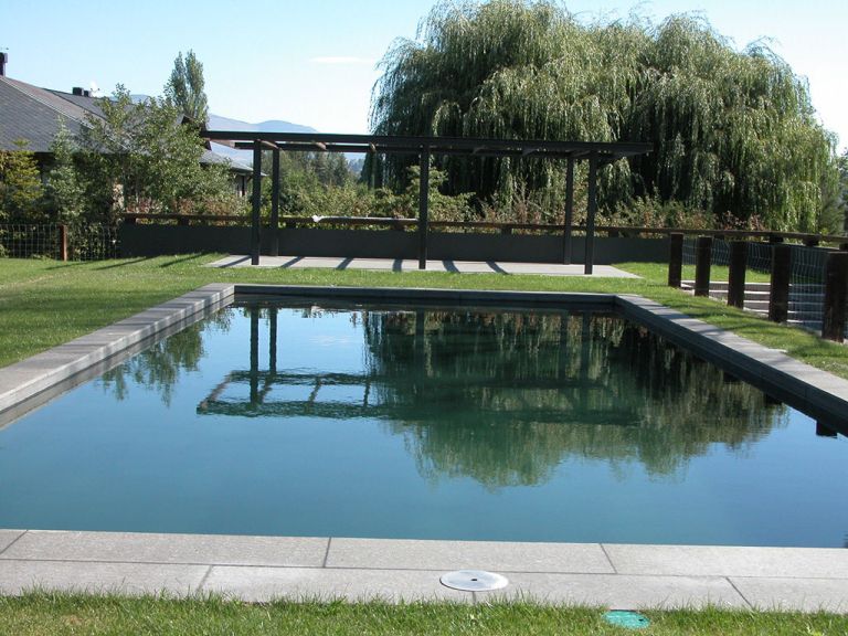 Piscina de agua oscura en jardín, proyecto de MA&MA POOL